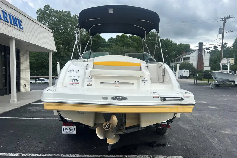 Slide: The Image of 2008 Chaparral Sunesta 244 boat with canopy, parked outside a marine shop. - 5