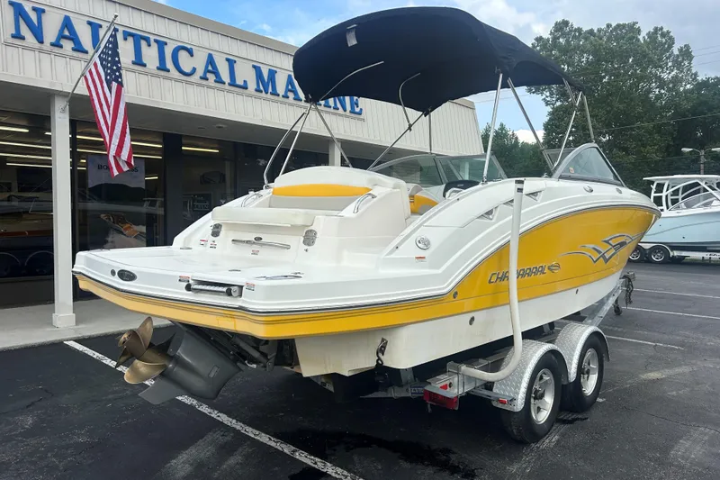 Slide: The Image of 2008 Chaparral Sunesta 244 boat with yellow accents on a trailer at a marine dealership. - 6