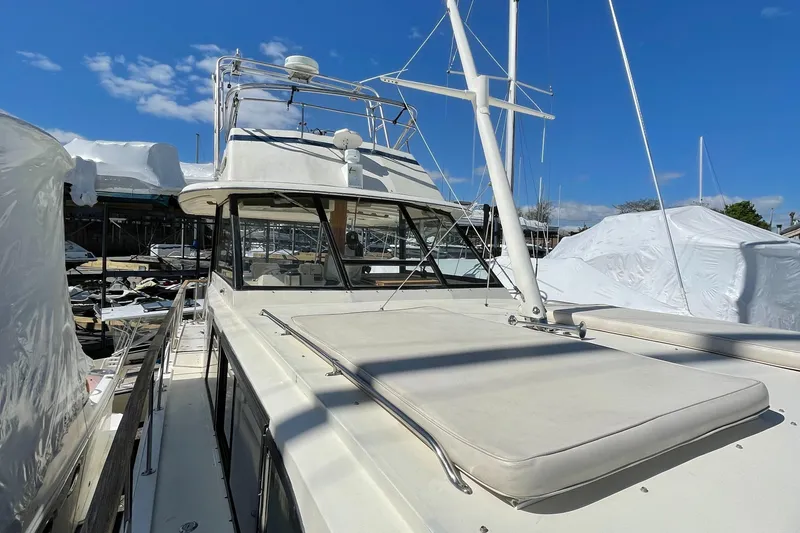 Slide: The Image of 1978 Hatteras 43 Double Cabin yacht docked, blue sky. - 13