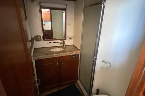 Slide: The Image of 1978 Hatteras 43 Double Cabin bathroom with shower and vanity. - 21