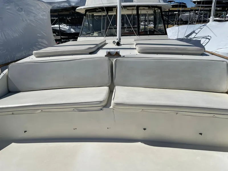 Slide: The Image of 1978 Hatteras 43 Double Cabin with white seating cushions. - 5