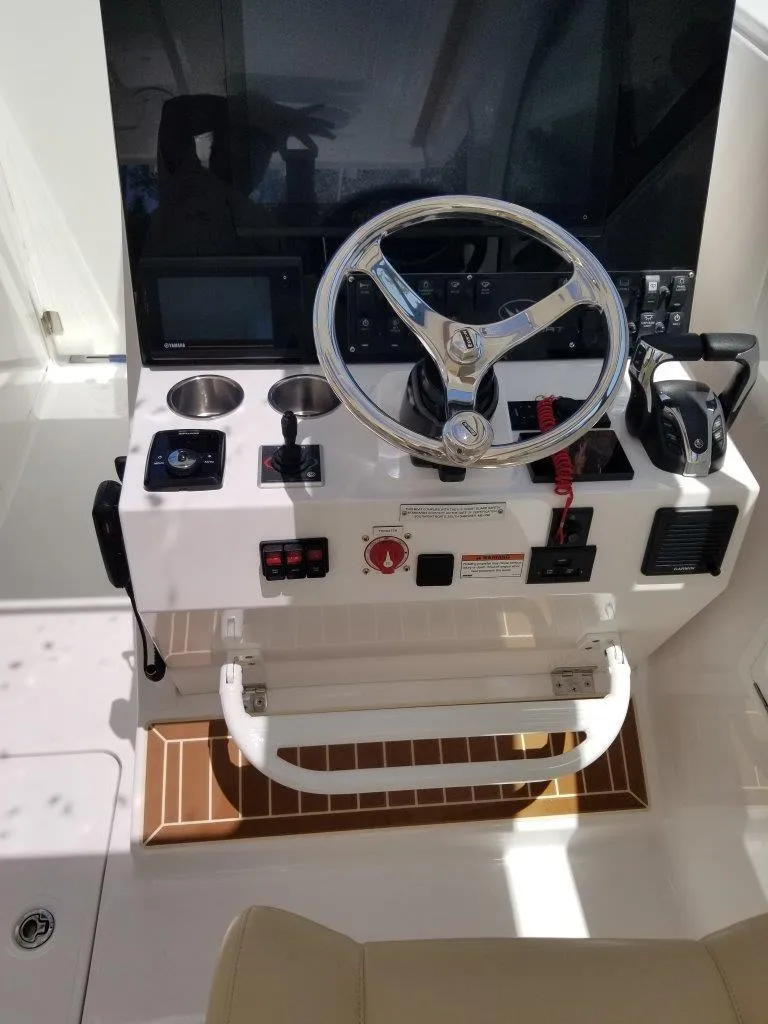 Slide: The Image of 2021 Southport 33 DC helm with steering wheel and controls. - 14