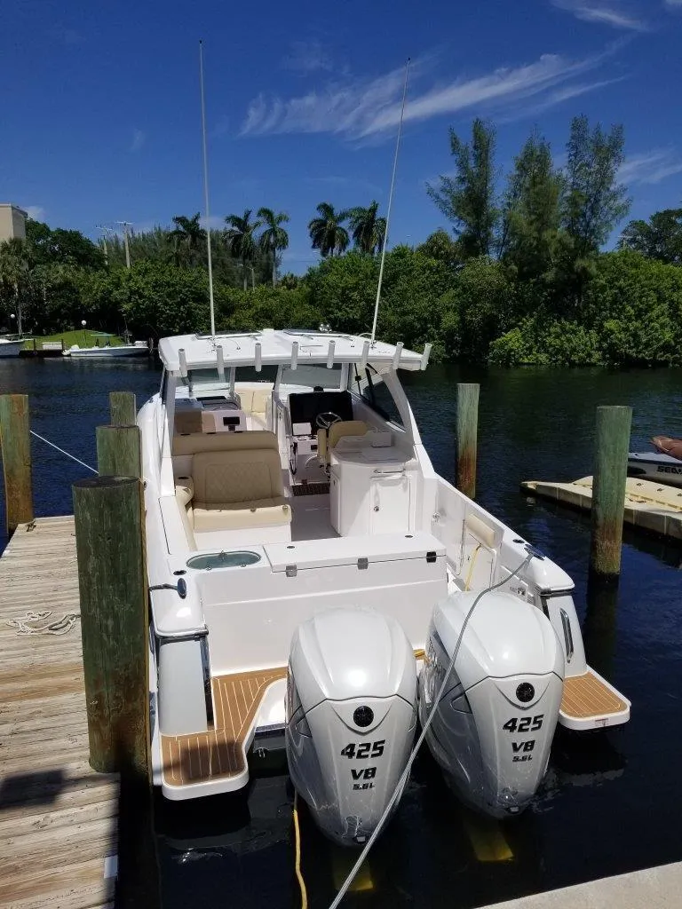 Slide: The Image of 2021 Southport 33 DC boat docked with twin outboard engines. - 2