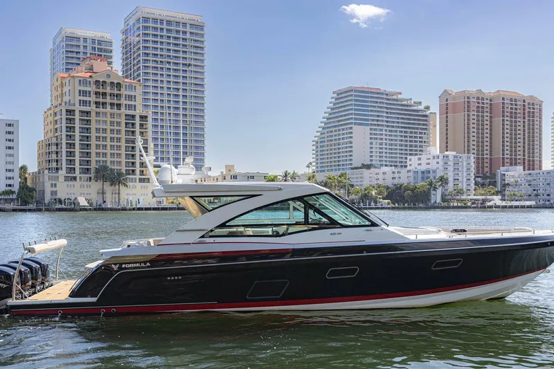 The Image of 2018 Formula 430 Super Sport Crossover yacht on water with city skyline backdrop. - 1