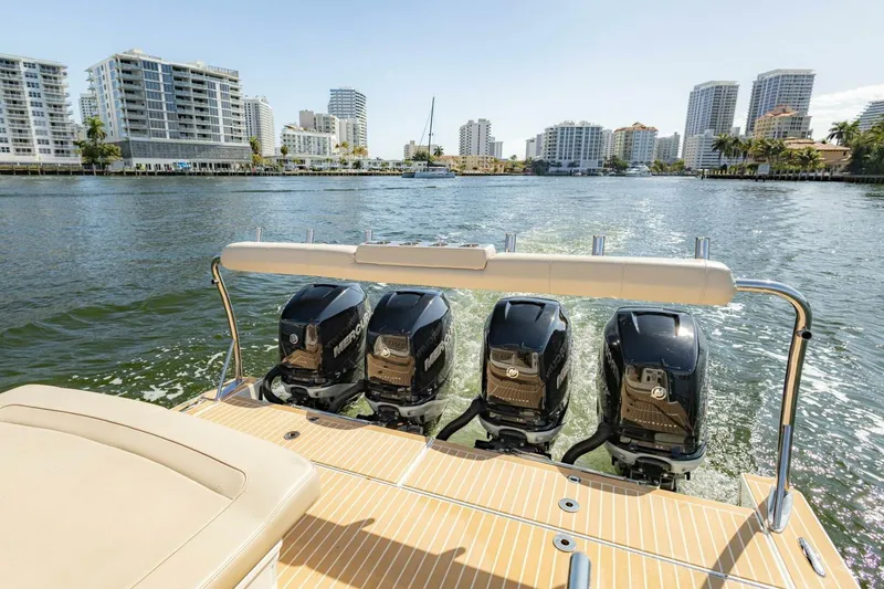 Slide: The Image of 2018 Formula 430 Super Sport Crossover with four outboard engines on a scenic waterway. - 14
