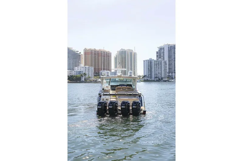Slide: The Image of 2018 Formula 430 Super Sport Crossover boat on water with city skyline backdrop. - 5
