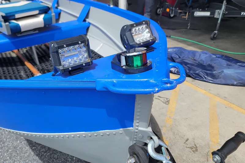 Slide: The Image of 1966 Sea Nymph V-14 boat with modern LED lights on blue and gray hull. - 8