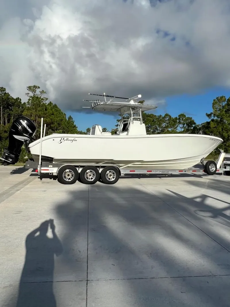 Slide: The Image of 2016 Yellowfin 32 Offshore boat on trailer under cloudy sky. - 2