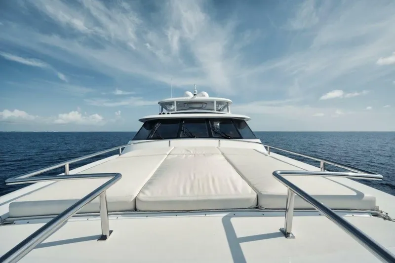 Slide: The Image of Luxury yacht Westport 112 cruising on open sea under clear blue sky. - 34