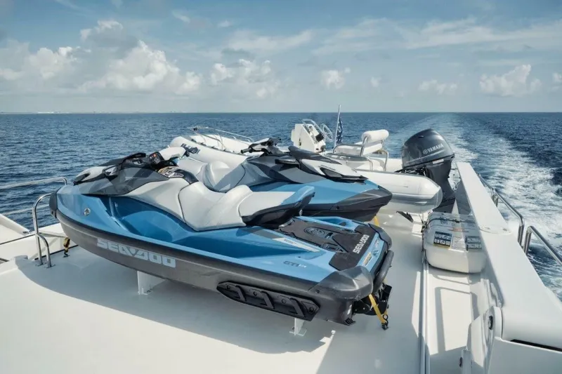 Slide: The Image of Two Sea-Doo jet skis on a 2002 Westport 112 yacht deck, cruising on open water. - 41