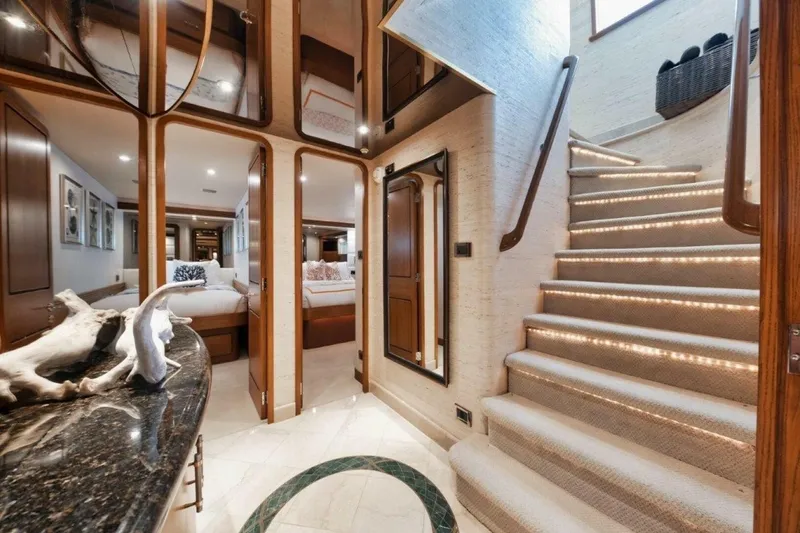 Slide: The Image of Luxurious interior of 2002 Westport 112 yacht with elegant staircase and modern decor. - 25
