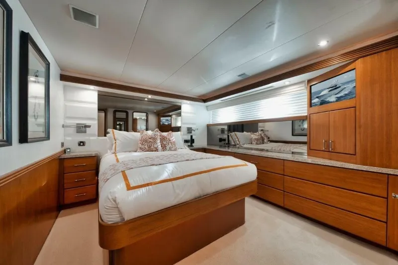 Slide: The Image of Luxurious bedroom interior of 2002 Westport 112 yacht with elegant wood furnishings. - 23