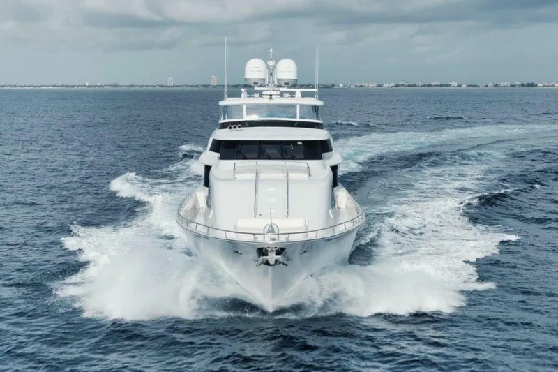 Slide: The Image of Luxurious 2002 Westport 112 yacht cruising on open sea under cloudy skies. - 45