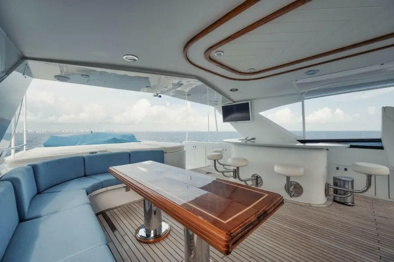 Slide: The Image of Luxurious 2002 Westport 112 yacht interior with seating, table, and ocean view. - 36