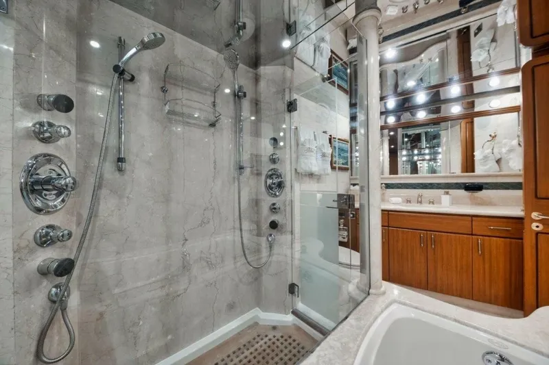 Slide: The Image of Luxurious bathroom with marble shower and wooden cabinetry on a 2002 Westport 112 yacht. - 22