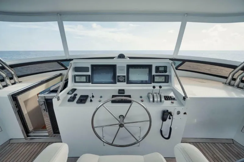 Slide: The Image of Helm of 2002 Westport 112 yacht with navigation controls and ocean view. - 37