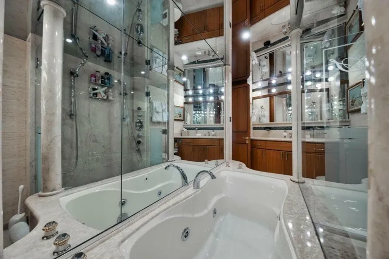Slide: The Image of Luxurious bathroom with marble jacuzzi and mirrored walls on 2002 Westport 112 yacht. - 21