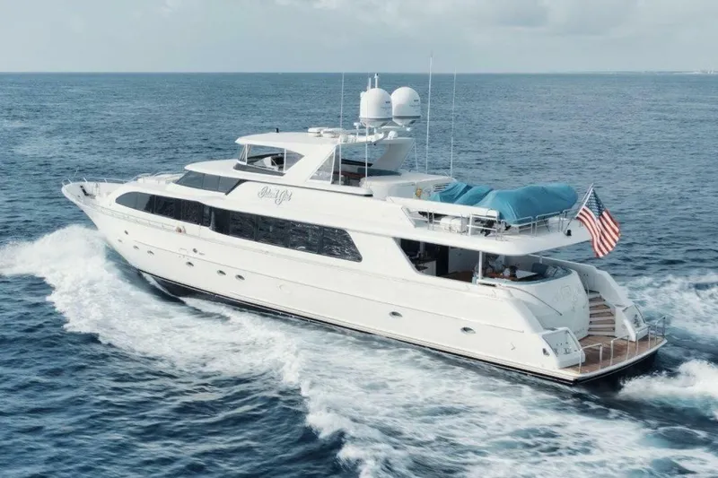 Slide: The Image of Luxurious 2002 Westport 112 yacht cruising on open sea with American flag. - 44