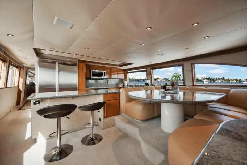 Slide: The Image of Luxurious interior of 2002 Westport 112 yacht with modern kitchen and dining area. - 28