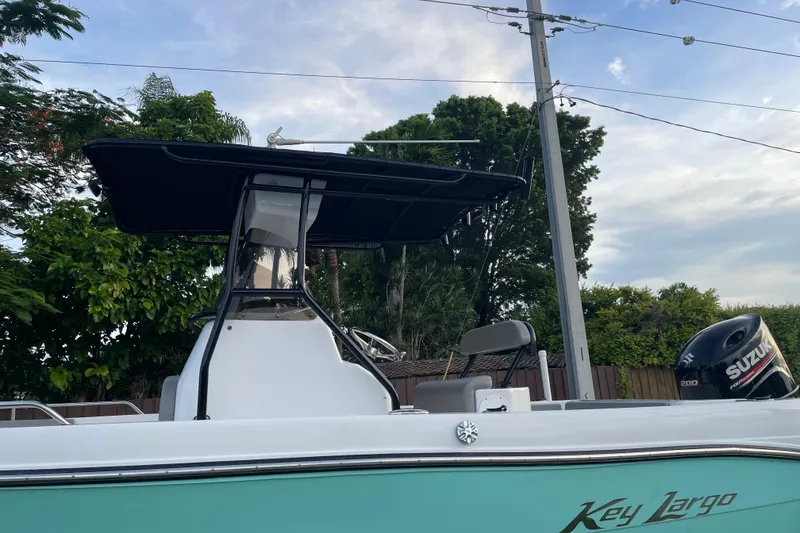 Slide: The Image of 2019 Key Largo 2100 CCW boat with Suzuki engine, parked outdoors. - 3