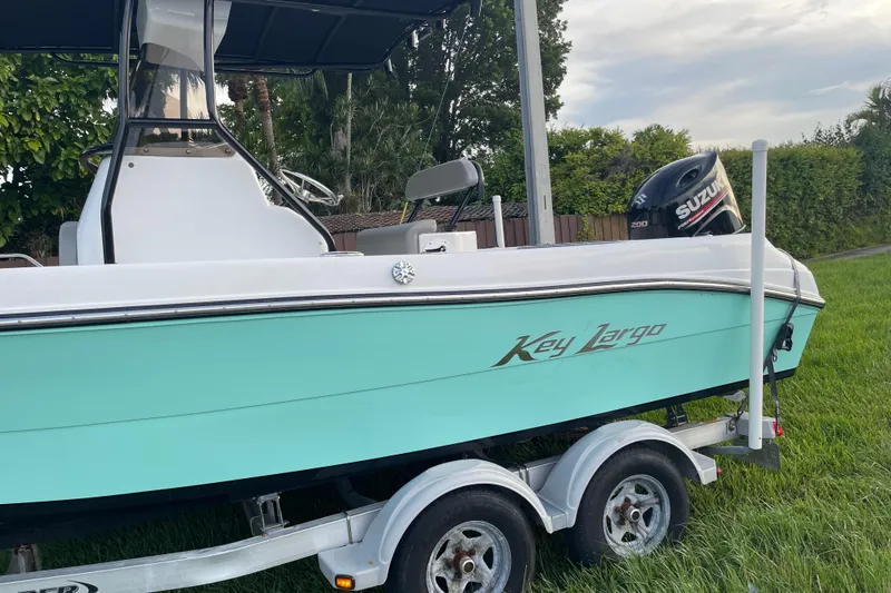 Slide: The Image of 2019 Key Largo 2100 CCW boat on trailer with Suzuki outboard motor. - 4
