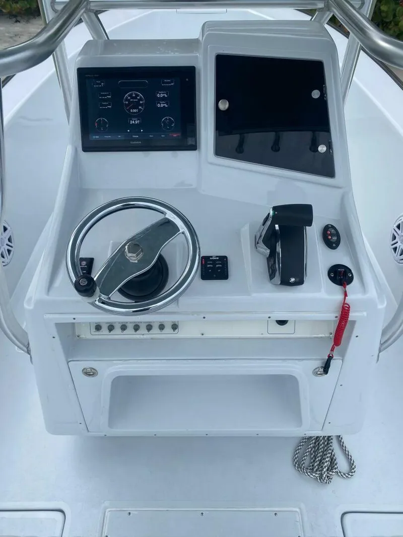 Slide: The Image of 1988 Intrepid 24 boat console with steering wheel, controls, and display screen. - 5