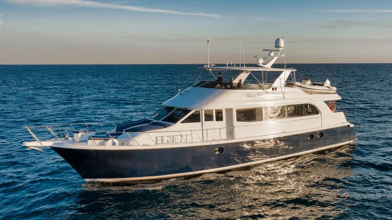 Slide: The Image of 2002 Hatteras Motor Yacht cruising on open sea under clear sky. - 3