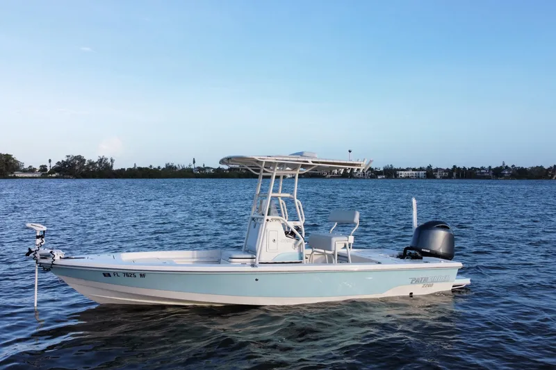 The Image of 2017 Pathfinder 2200 TRS boat on calm water under clear blue sky. - 0