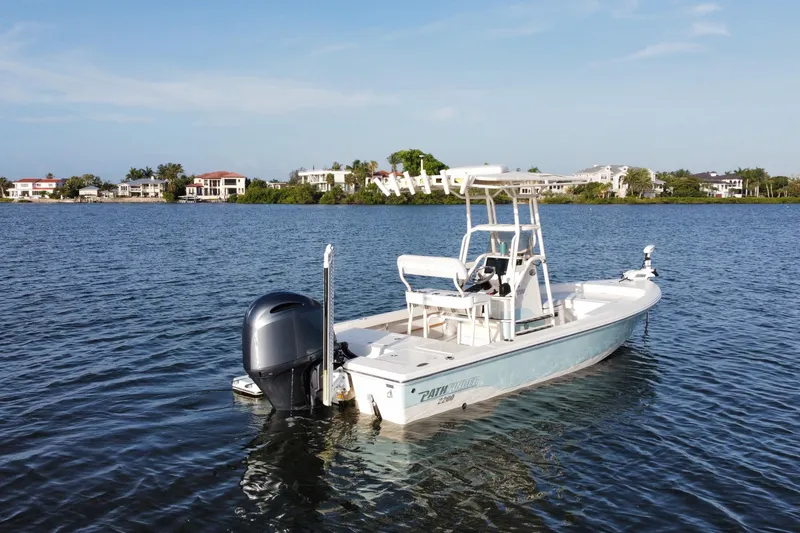 Slide: The Image of 2017 Pathfinder 2200 TRS boat on calm water near waterfront homes. - 12