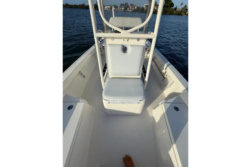 Slide: The Image of 2017 Pathfinder 2200 TRS boat interior with seating, on calm water. - 15