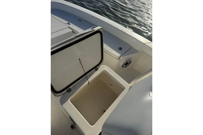 Slide: The Image of Open storage compartment on 2017 Pathfinder 2200 TRS boat, near water. - 16