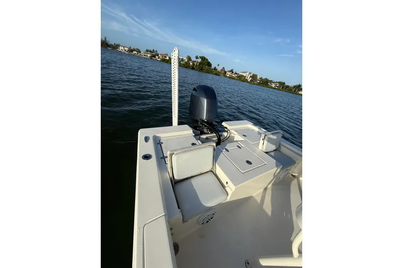 Slide: The Image of 2017 Pathfinder 2200 TRS boat on calm water, featuring a sleek design and powerful motor. - 21