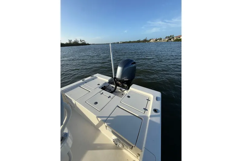 Slide: The Image of 2017 Pathfinder 2200 TRS boat on calm water, featuring a sleek outboard motor. - 22