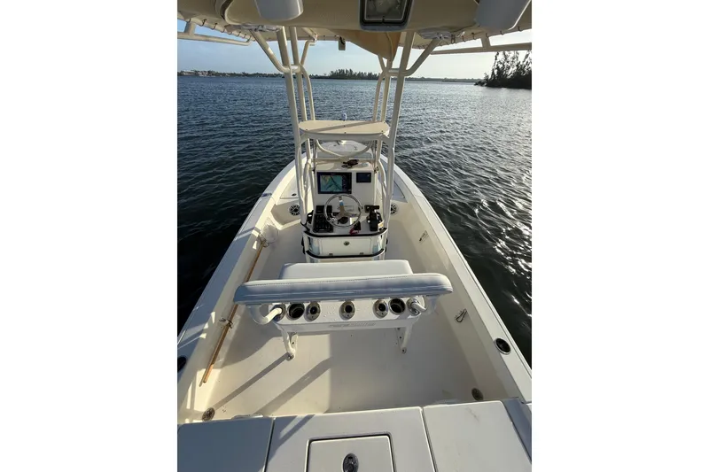 Slide: The Image of 2017 Pathfinder 2200 TRS boat interior with console, on calm water. - 24