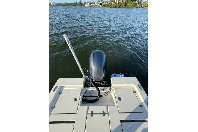 Slide: The Image of 2017 Pathfinder 2200 TRS boat on water, featuring outboard motor and spacious deck. - 26