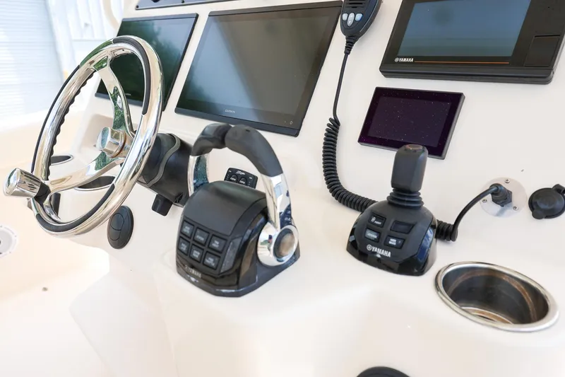 Slide: The Image of Control panel of 2020 Grady-White Canyon 336 boat with steering wheel and navigation screens. - 16