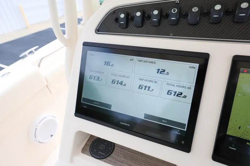 Slide: The Image of Grady-White Canyon 336 dashboard with Garmin display showing trip data and fuel usage. - 19