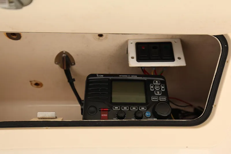 Slide: The Image of 2020 Grady-White Canyon 336 boat radio and control panel in storage compartment. - 22