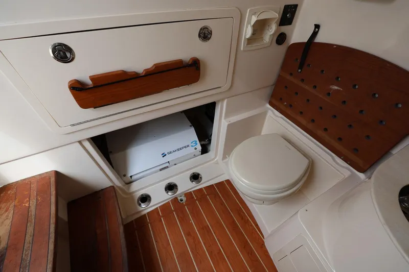 Slide: The Image of 2020 Grady-White Canyon 336 boat interior with Seakeeper 3 stabilizer and marine toilet. - 28