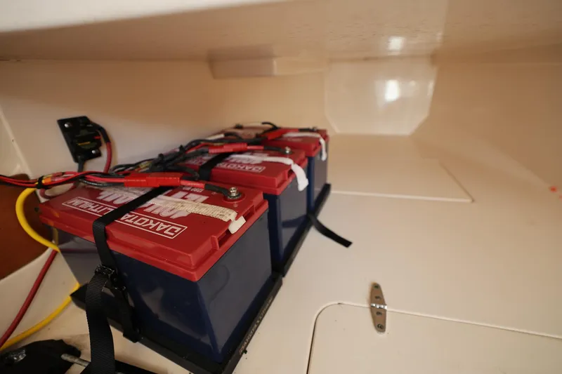 Slide: The Image of Battery compartment of 2020 Grady-White Canyon 336 boat, featuring secured marine batteries. - 32