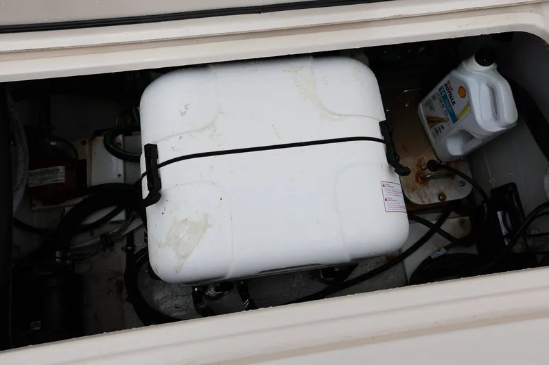 Slide: The Image of Engine compartment of 2020 Grady-White Canyon 336 with white container and oil bottle. - 34