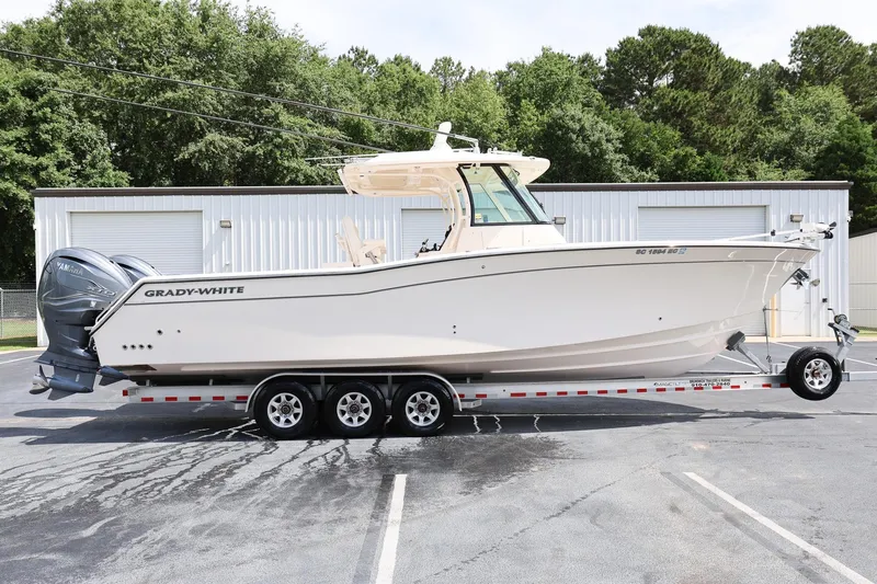 Slide: The Image of 2020 Grady-White Canyon 336 boat on trailer, parked outdoors near a building. - 5