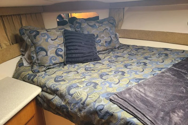 Slide: The Image of Cozy cabin bedroom in 2003 Carver 356 Aft Cabin Motor Yacht with patterned bedding. - 10