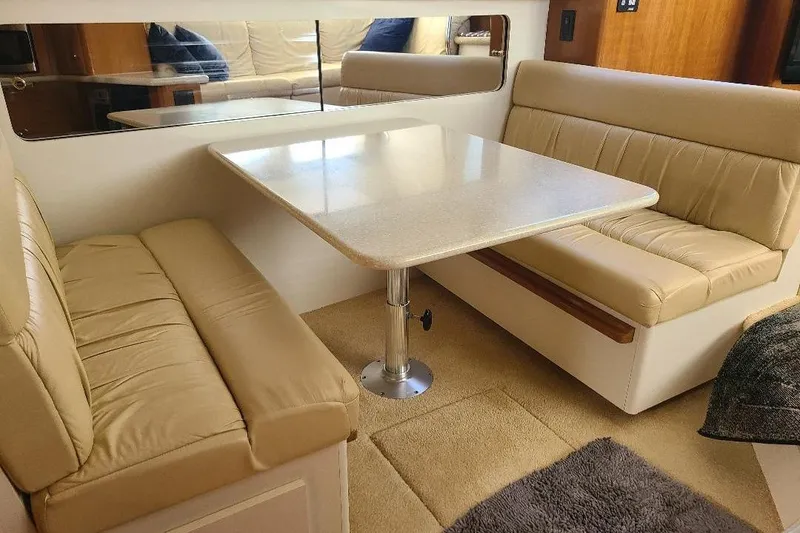 Slide: The Image of Interior of 2003 Carver 356 Aft Cabin Motor Yacht with beige seating and table. - 13