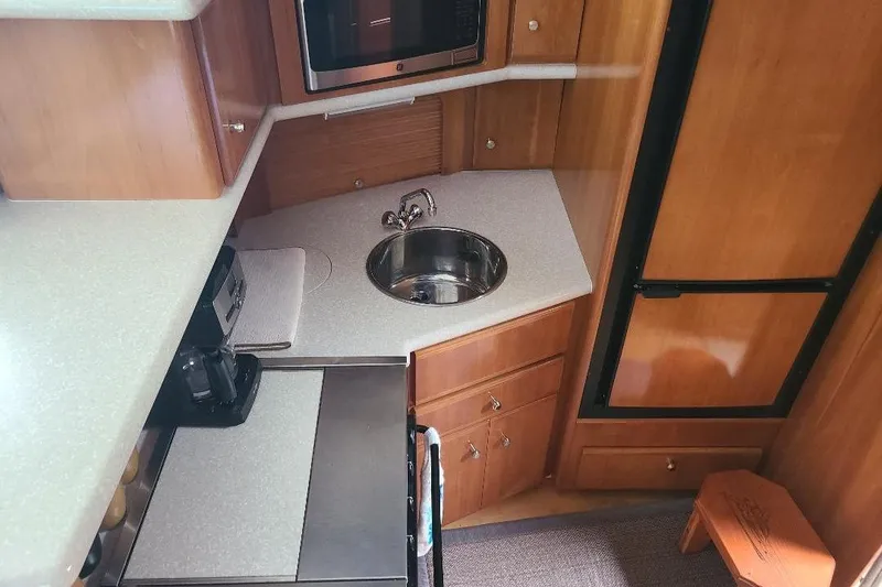 Slide: The Image of Interior of 2003 Carver 356 Aft Cabin Motor Yacht kitchen with sink and appliances. - 15