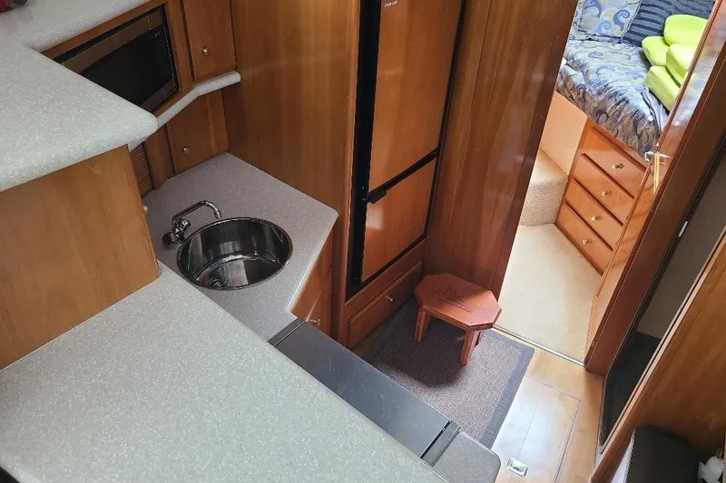 Slide: The Image of Interior of 2003 Carver 356 Aft Cabin Motor Yacht with kitchenette and cozy cabin. - 16