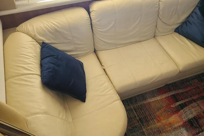 Slide: The Image of Cream leather sofa with blue cushions in a 2003 Carver 356 Aft Cabin Motor Yacht. - 19
