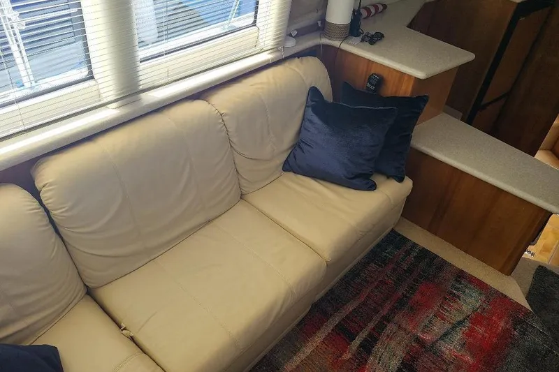 Slide: The Image of Interior of 2003 Carver 356 Aft Cabin Motor Yacht with beige sofa and blue pillow. - 21