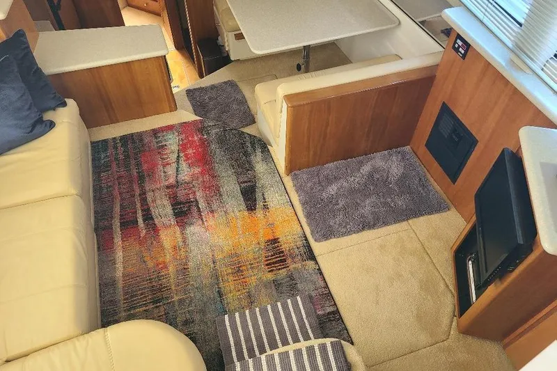 Slide: The Image of Interior of 2003 Carver 356 Aft Cabin Motor Yacht with colorful rug and seating area. - 23