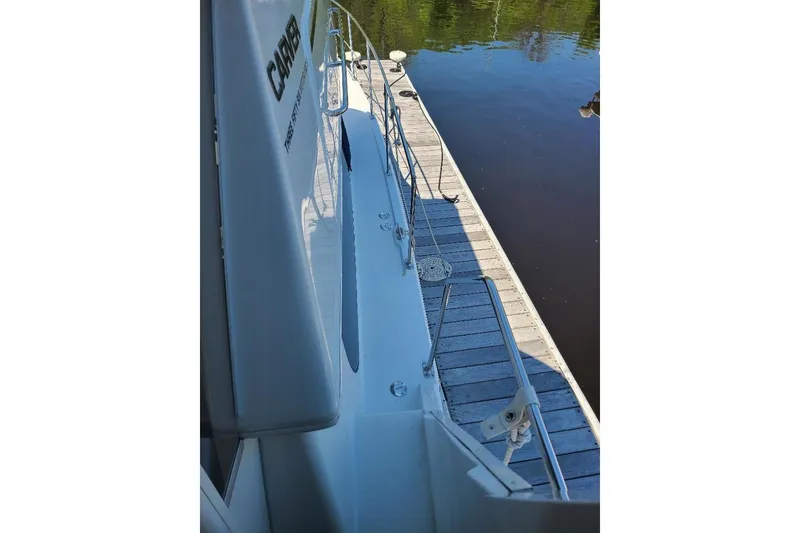 Slide: The Image of 2003 Carver 356 Aft Cabin Motor Yacht docked beside a wooden pier. - 25